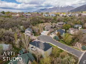 Aerial view of property's location featuring nearby suburban area and a mountainous background