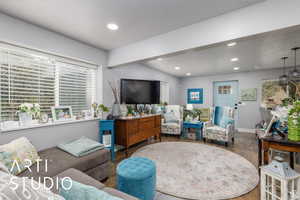 Living area featuring healthy amount of natural light, a textured ceiling, recessed lighting, and wood finished floors