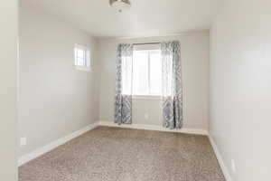 Unfurnished room with carpet floors and baseboards