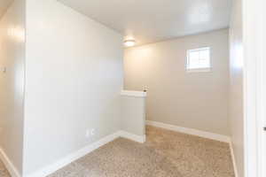 Carpeted empty room with baseboards