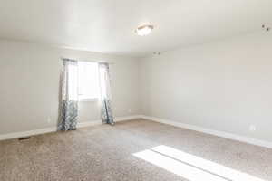 Unfurnished room with carpet and baseboards