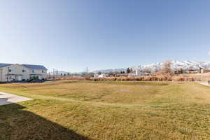 View of green lawn featuring a mountain view
