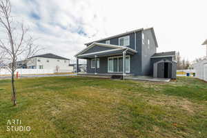Back of house with a shed, stucco siding, and a porch
