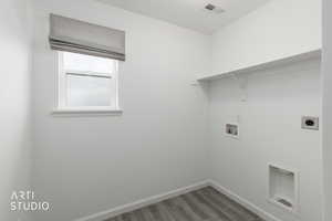 Washroom with washer hookup, light wood finished floors, and electric dryer hookup