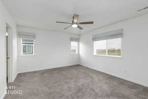 Spare room featuring carpet floors and ceiling fan