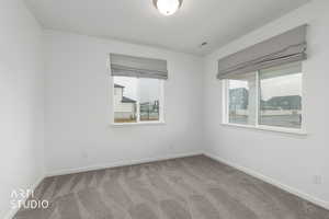 Carpeted empty room with baseboards