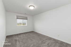 Carpeted empty room with baseboards