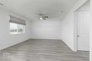 Spare room featuring light wood-style floors and ceiling fan