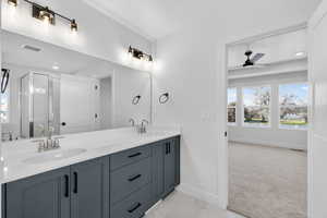 Bathroom with double vanity, plenty of natural light, ceiling fan, a stall shower, and recessed lighting