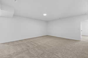 Empty room featuring light colored carpet and recessed lighting