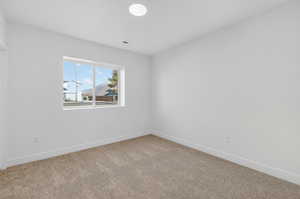 Empty room with carpet flooring and baseboards