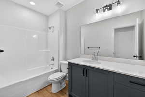 Full bathroom with  shower combination, vanity, and light wood-type flooring