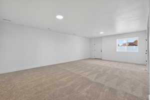 Spare room with light colored carpet and recessed lighting