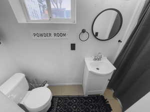 Full bathroom with vanity, light tile patterned flooring, and a shower with curtain