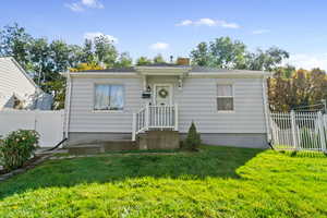 Bungalow-style house featuring a gate and roof with shingles
