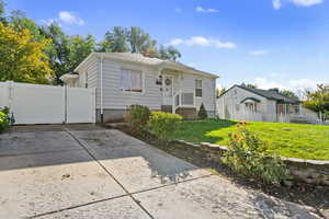 Bungalow-style house featuring a gate and a chimney