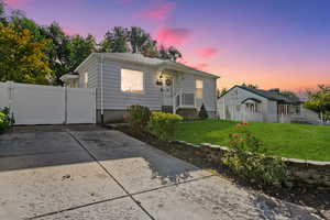 Bungalow-style home featuring a gate and concrete driveway