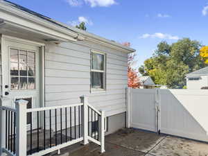 Entrance to property featuring a patio and a gate