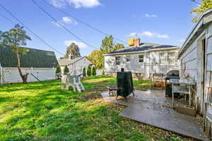 Fenced backyard with a patio area and an outdoor fire pit
