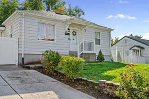 View of front of home featuring a gate and roof with shingles