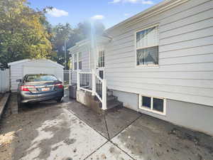 View of home's exterior with a garage and an outdoor structure