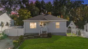 View of front of property with a gate and a shingled roof