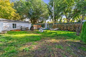 Fenced backyard with an outdoor fire pit