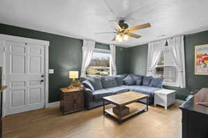 Living room featuring wood finished floors and a ceiling fan