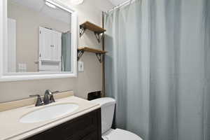 Full bathroom featuring a shower with curtain and vanity