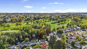 Aerial perspective of suburban area featuring a golf course