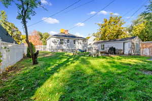 Rear view of property featuring a fenced backyard, a chimney, and a patio