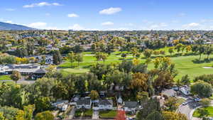 Aerial perspective of suburban area featuring a local golf course