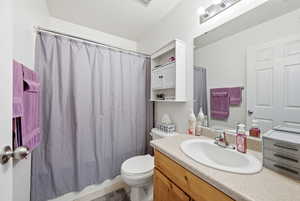 Bathroom with vanity and shower / tub combo with curtain