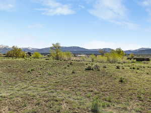View of mountain backdrop featuring rural landscape