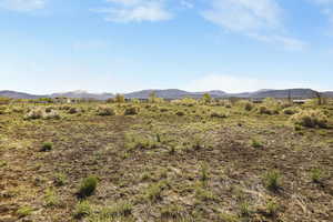 View of mountain backdrop with rural landscape
