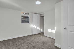 Unfurnished bedroom featuring carpet flooring and baseboards