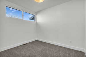 Spare room with baseboards and carpet