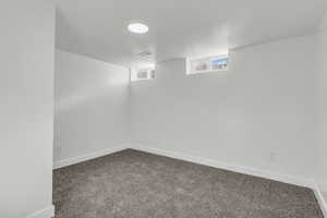 Unfurnished room with carpet flooring and baseboards