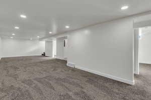 Finished basement featuring carpet floors and recessed lighting