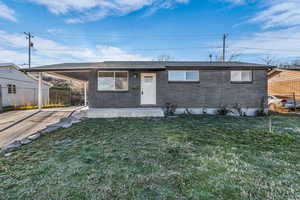 Ranch-style house featuring brick siding, an attached carport, concrete driveway, and roof with shingles