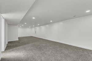 Finished basement featuring carpet, recessed lighting, and a textured ceiling