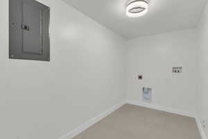 Washroom featuring electric panel, electric dryer hookup, and washer hookup