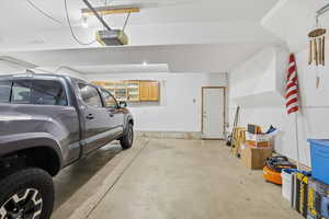 Garage featuring a garage door opener