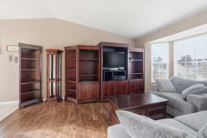 Living area featuring vaulted ceiling and LVP flooring