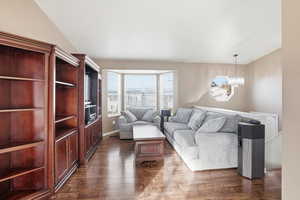 Living room with a bay window and dark LVP flooring
