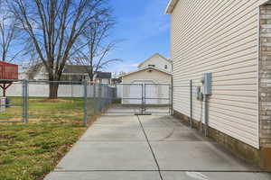 View of RV pad, gate and detached garage