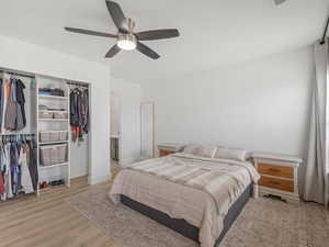 Primary Bedroom with light wood-style floors, a closet, and a ceiling fan