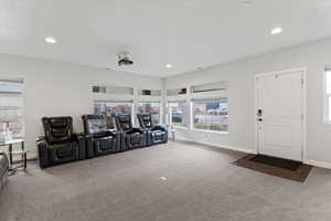 Cinema/Living Room featuring carpet flooring, plenty of natural light, recessed lighting, and a textured ceiling