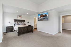 Master Bedroom featuring light carpet, recessed lighting, and ensuite bathroom
