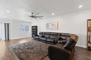 Living area featuring wood finished floors, a ceiling fan, recessed lighting, and a textured ceiling